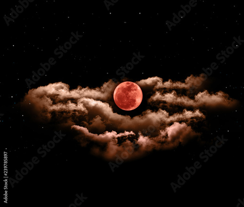 Lunar eclipse or blood full moon with clouds