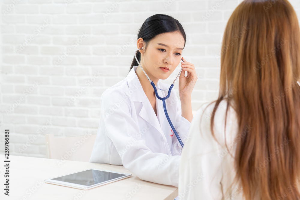 Female doctor talking to patient.Doctor and patient discussing something while sitting at the table . Medicine and health care concept. Doctor and patient Female doctor talking to patient.Doctor and patient discussing something while sitting at the table . Medicine and health care concept. Doctor and patient