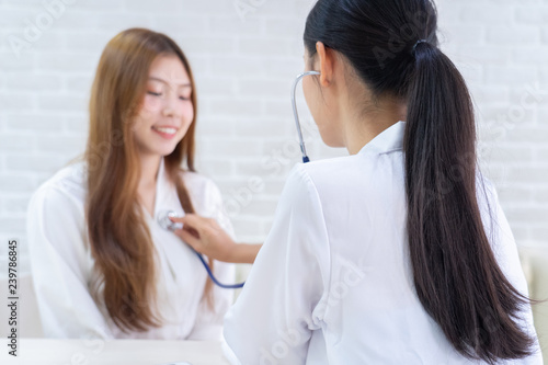 Female doctor talking to patient.Doctor and patient discussing something while sitting at the table . Medicine and health care concept. Doctor and patient