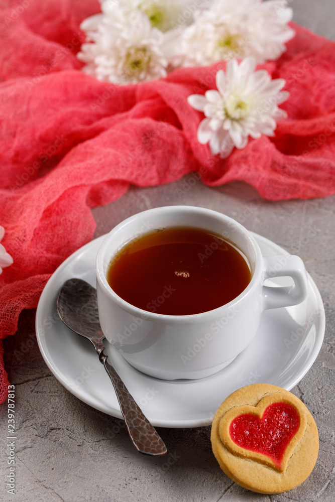 A cup of tea and biscuits with hearts. Beautiful still life with a cup of tea, the mood of Valentine's Day. A cup of tea and biscuits with hearts. Beautiful still life with a cup of tea, the mood of Valentine's Day.