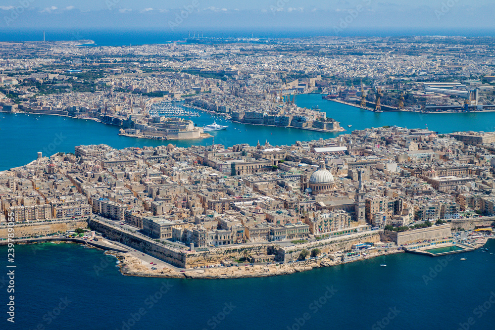 Malta aerial view. Valetta, capital city of Malta, Grand Harbour, Senglea and Il-Birgu (Vittoriosa) towns, Fort Ricasoli and Fort Saint Elmo from above. Marsaxlokk city and Freeport in background