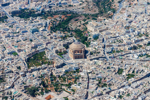 Famous Mosta Dome (Rotunda of Mosta, The Basilica of the Assumption of Our Lady Mary) aerial view. Roman Catholic parish church and Minor Basilica in Mosta, Malta. Malta from above photo