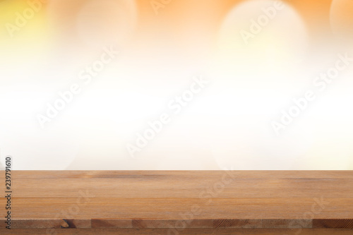 Empty desk with blurred light orange gradient bokeh abstract background