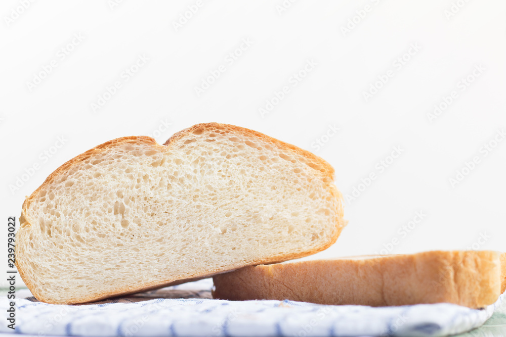 Fresh home made bread on white table background with napkin