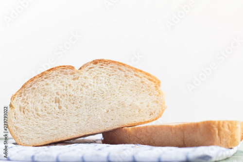 Fresh home made bread on white table background with napkin