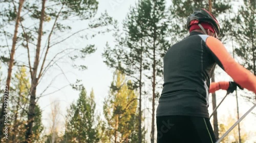 Wallpaper Mural Training an athlete on the roller skaters. Biathlon ride on the roller skis with ski poles, in the helmet. Autumn workout. Roller sport. Adult man riding on skates. Shooting an athlete in motion Torontodigital.ca
