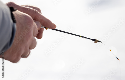 Man catches fish on ice in winter