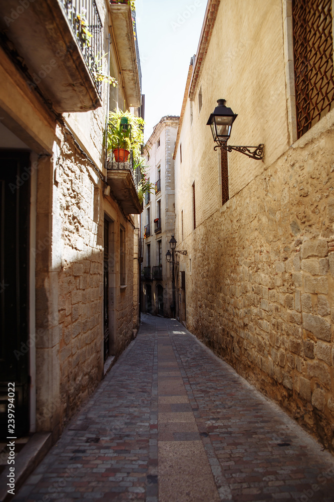 Narrow street in the old city of Girona, Spain