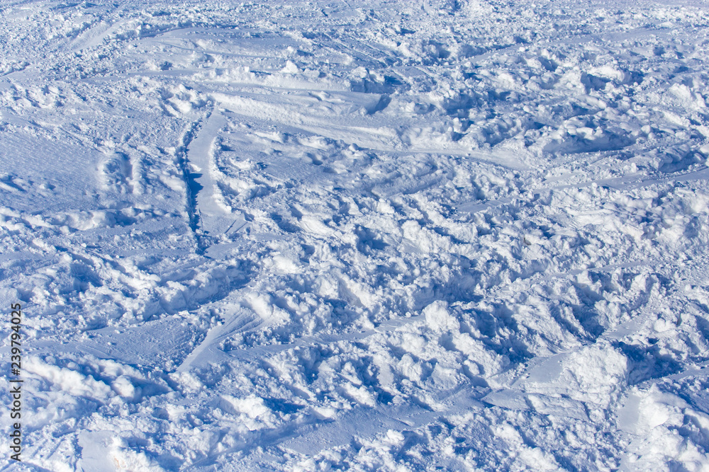 Traces of skiers on white snow in the mountains Traces of skiers on white snow in the mountains