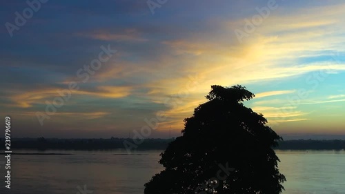The sun is setting behind the city of Savannakhet in Laos as seen from Mukdahan in Thailand.