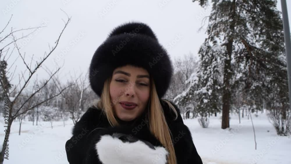 Portrait of a young girl in a hat with white gloves in the winter forest. Portrait of a young girl in a hat with white gloves in the winter forest.
