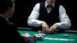 Casino croupier matching bet of player going all-in, betting all money and keys