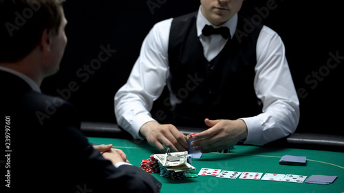 Casino player going all-in, betting all money and property keys, gambling man photo