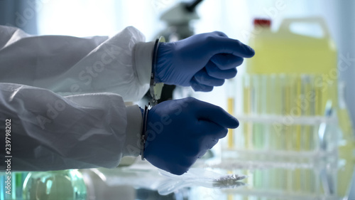 Fotografie Lab assistant handcuffed for illegal drug dealing clandestine pharmaceutical lab
