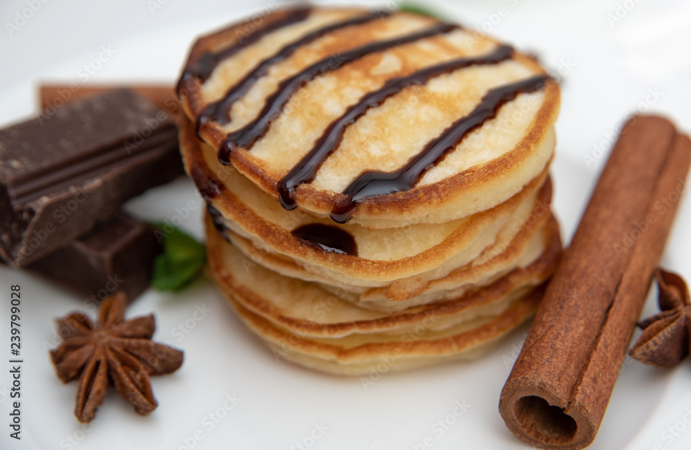 Pancakes with chocolate sauce decorated with fresh mint Pancakes with chocolate sauce decorated with fresh mint