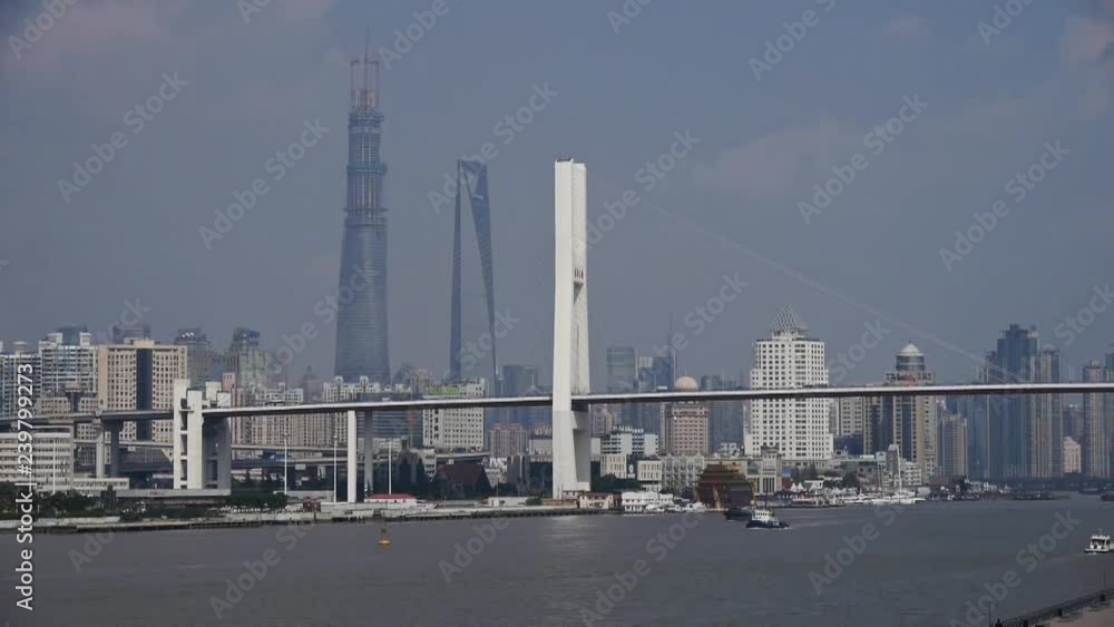 busy shipping on huangpu river,across the sea bridge in shanghai,nanpu bridge,modern urban building background. busy shipping on huangpu river,across the sea bridge in shanghai,nanpu bridge,modern urban building background.