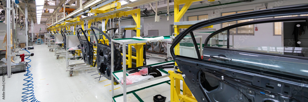 Production of automobile doors. Long format. Wide angle view of plant of automotive industry. Can be used as banner