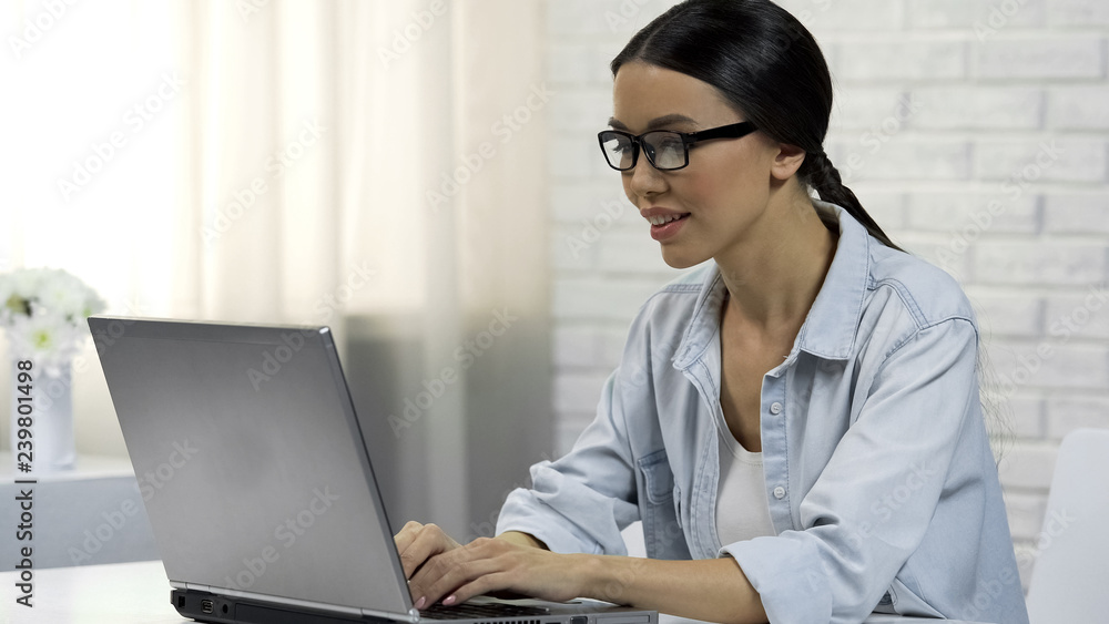 Woman typing on laptop chatting in social network, answering messages online Woman typing on laptop chatting in social network, answering messages online