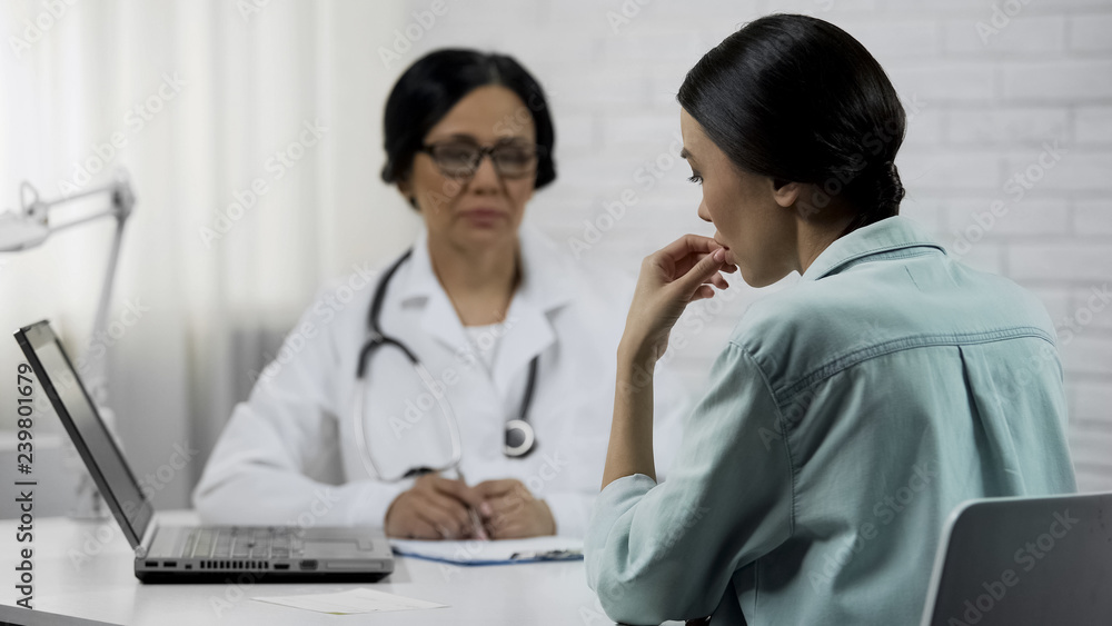 Practitioner informing young patient about bad diagnosis, incurable disease Practitioner informing young patient about bad diagnosis, incurable disease