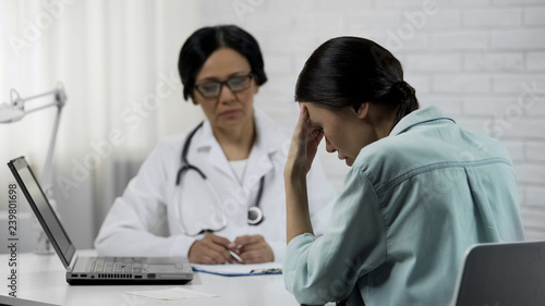 Female doctor informs about bad diagnosis, patient upset incurable disease photo