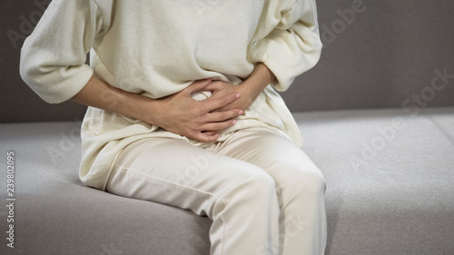 Lady suffering from strong stomach ache, gastritis, problems with gall bladder photo
