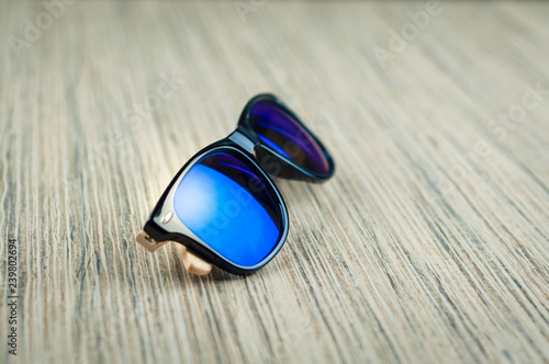 fashionable blue sunglasses wooden on the table