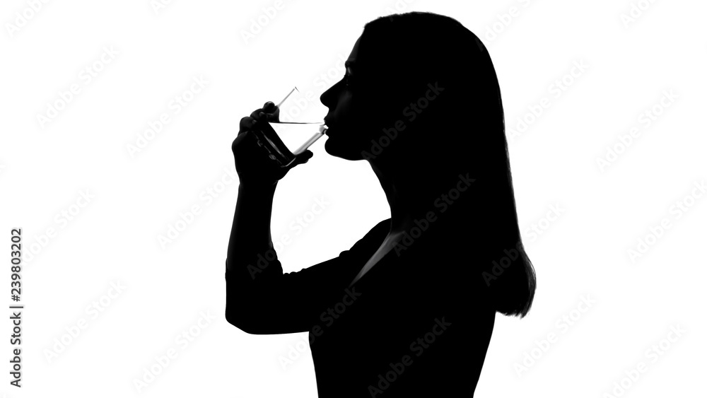 Woman drinking glass of water, restoring balance, silhouette, nutrition