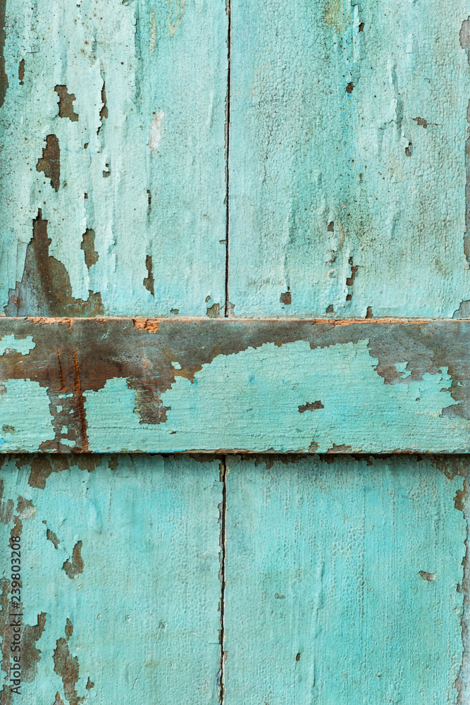 Old Wood door paint green color peeling texture background with copy space