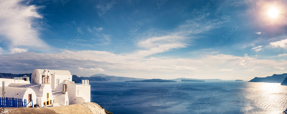 Obraz premium Panorama view of Santorini island in Greece, on a sunny day with beautiful sky. Scenic travel background.