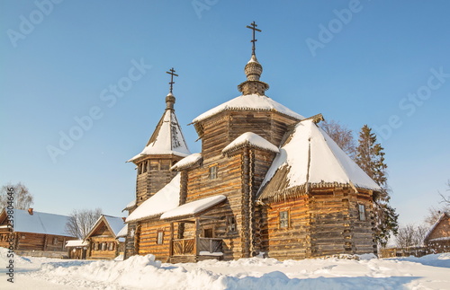 Fototapeta Naklejka Na Ścianę i Meble -  Russian rural winter landscape with an old log church
