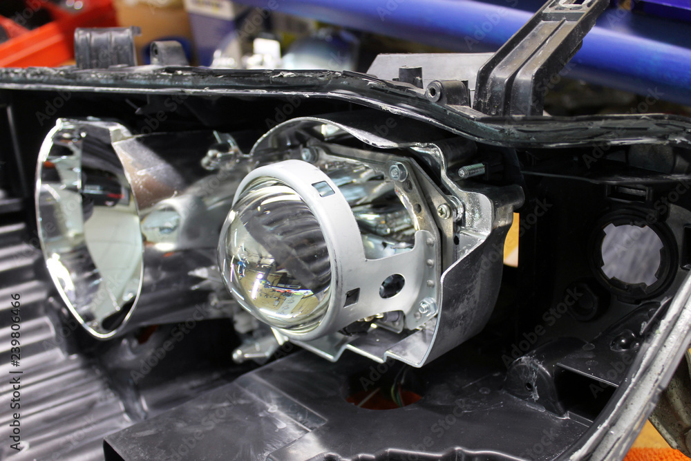 Repairing, installation and tuning headlight of modern automobile and car projector lens. Vehicle head xenon lamp in details. Concept of auto detailing, light and LED technology Repairing, installation and tuning headlight of modern automobile and car projector lens. Vehicle head xenon lamp in details. Concept of auto detailing, light and LED technology
