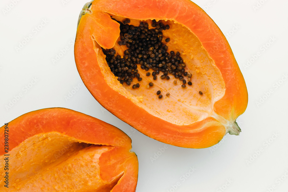 Papaya on a white background with clipping path, creative food concept, tropical fruit flat lay Papaya on a white background with clipping path, creative food concept, tropical fruit flat lay