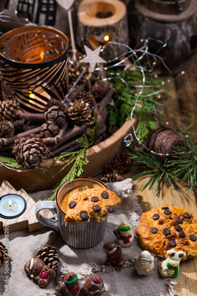 Fragrant hot coffee and chocolate cookies for Santa Claus. A drink for the holiday and a cozy Christmas atmosphere. Free space for text.