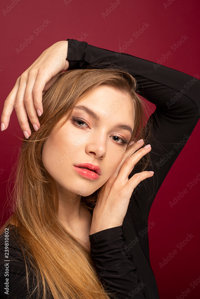 sexy blond long hair girl is standing at the red background sexy blond long hair girl is standing at the red background