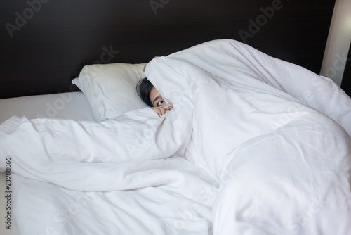 Quadro em tela Nightmare or bad dream,Woman with scare and panic while lying down under the bla