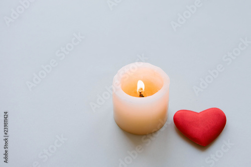 Burning candle and heart.  photo