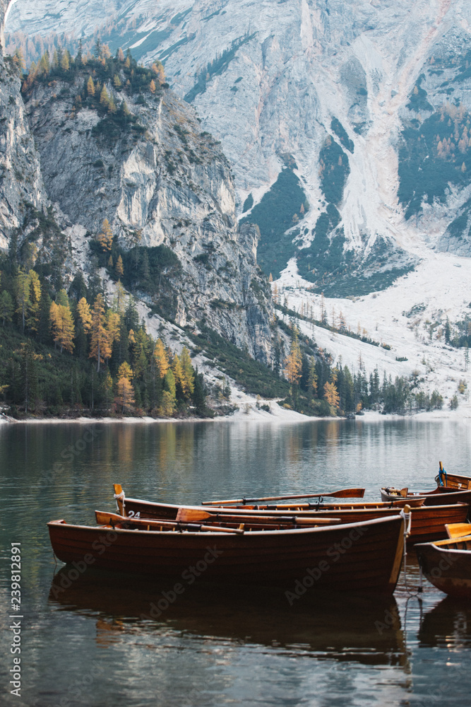 vintage wooden boats on the calm lake and beautiful mountains at Dolomities,Lago Di Braies