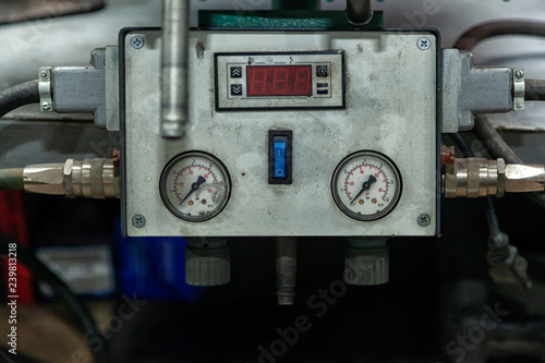 Close-up of a vulcanizer apparatus with buttons and screens in a car repair shop. Control panel with pressure sensors and indicator...