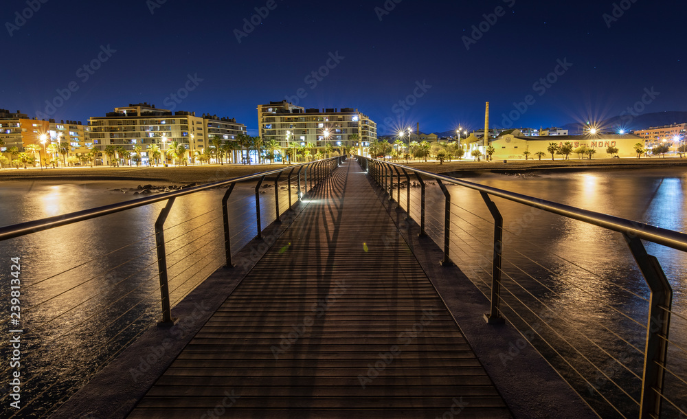 Bridge to the city at night