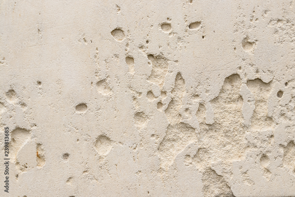 Fototapeta premium Beige wall with holes. Background or texture for design.