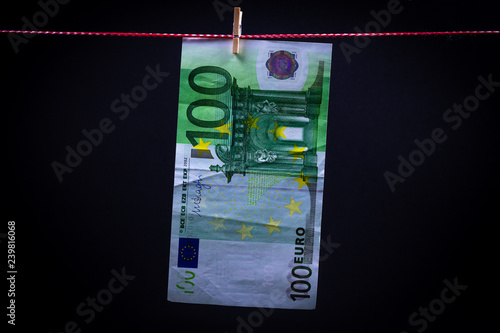 euro bills on a rope with clothespins