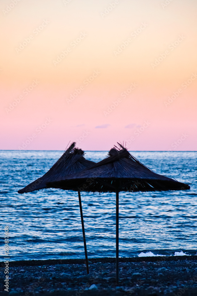 Beach umbrellas made of palm leaves