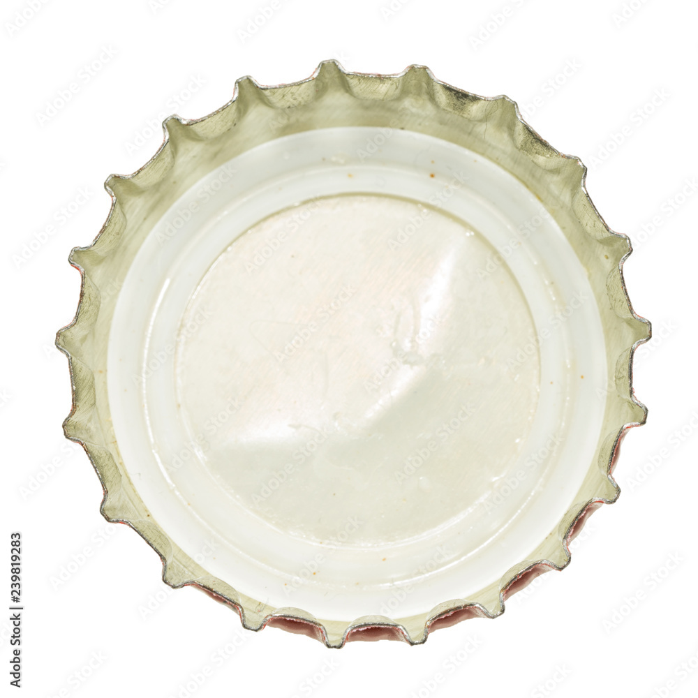 The bottom (inside) part of empty used metal cap, used for glass soda bottles. Isolated on white background. The bottom (inside) part of empty used metal cap, used for glass soda bottles. Isolated on white background.