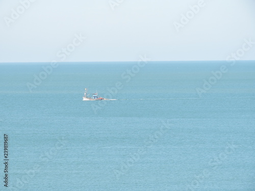 Beach side shots under sunny conditions with a boat in the sea © sankar1991