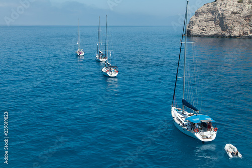 A flotilla of sailing yachts out of the bay.