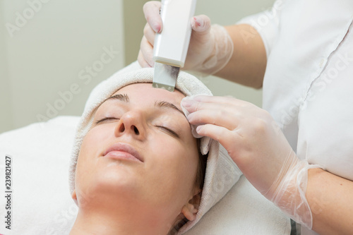 Face skin care. Beautician applying beauty oil mask on face using brush In spa salon