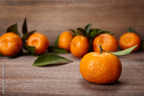 A pile of ripe tangerines  on wooden background.