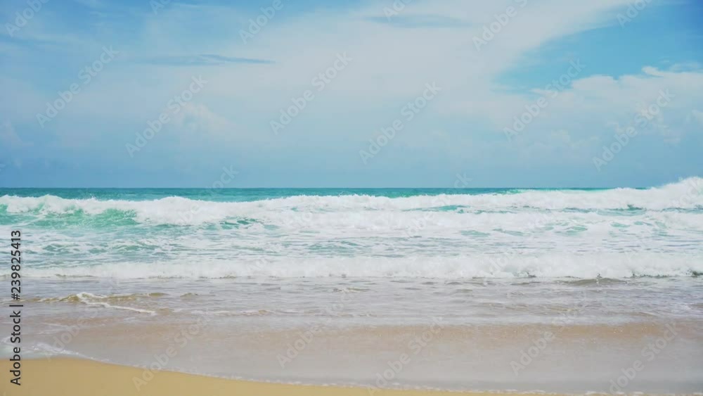 Tropical beach wave and sand and rocks with summer blue sky. Tropical beach wave and sand and rocks with summer blue sky.
