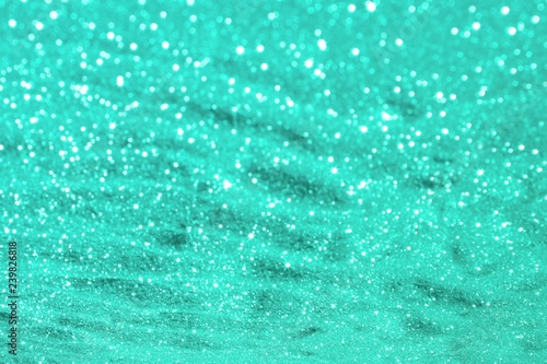 light blue shining metallic sand made of glitters - shining concept with bokeh texture - beautiful abstract photo background