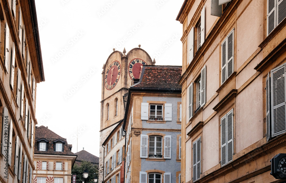 Diesse Tower clock tower among old buildings in Medieval ancient town of Neuchatel